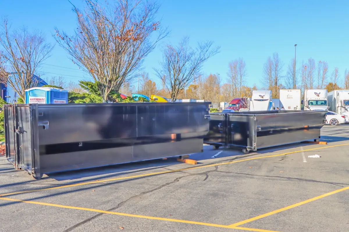 Professional dumpster rental service with roll-off container on residential driveway in Scenic Oaks